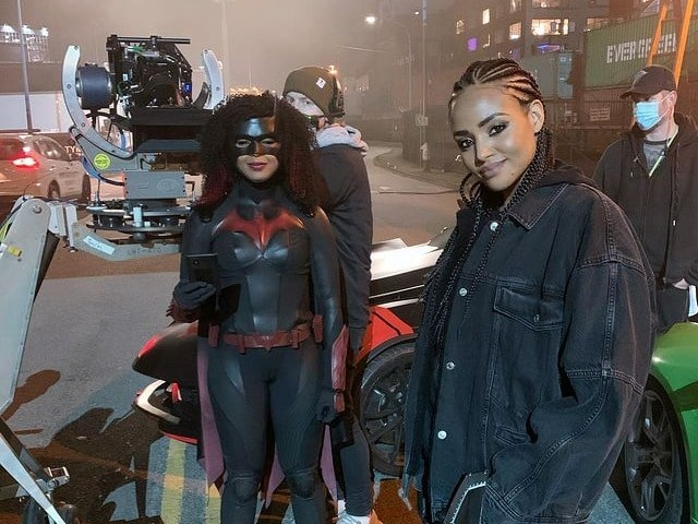 Image of Tendy wearing a black jeans jacket n hoodie, whereas an actress of Batwoman wearing suits of batwoman with the production team